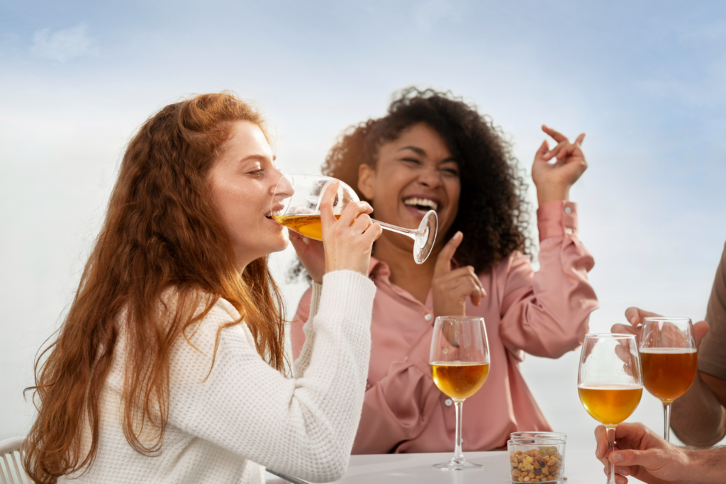 Two women drinking from champagne glasses.